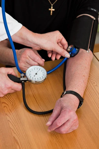Doctor patient attaches the blood pressure