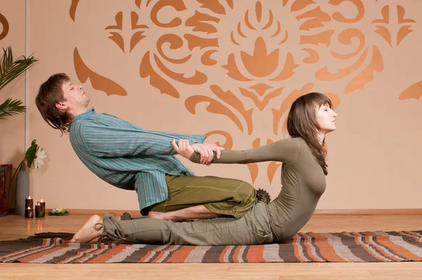 Couple doing yoga. Massage