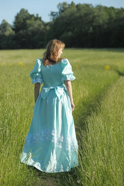 Young woman in an retro dress in the field