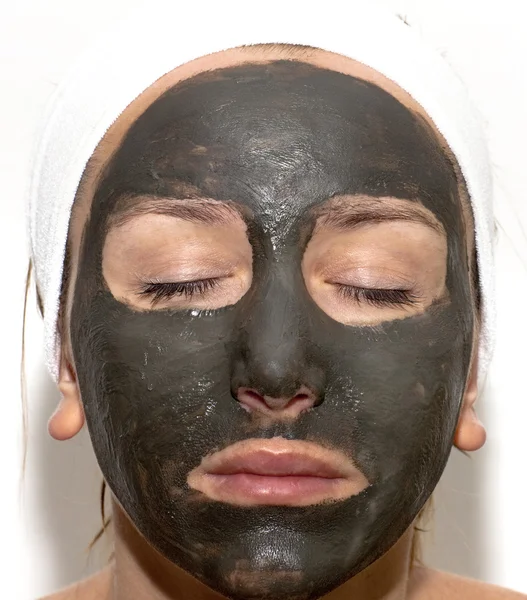 Deep sea mud mask treatment on the woman face