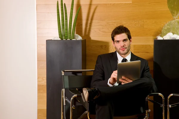 Business man waiting in office lobby
