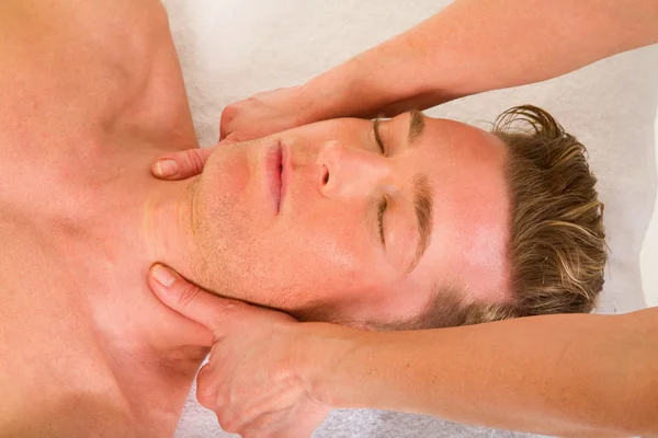 Young man receives a neck massage
