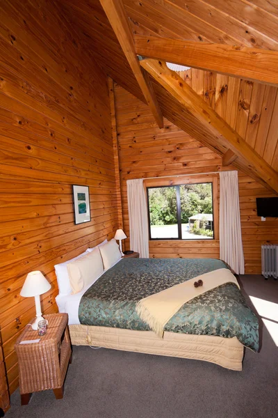 Interior of mountain wooden lodge double bedroom