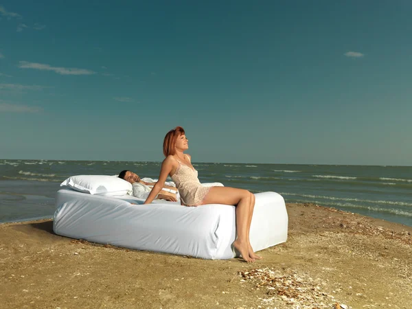 Happy couple relaxind on bed sea shore