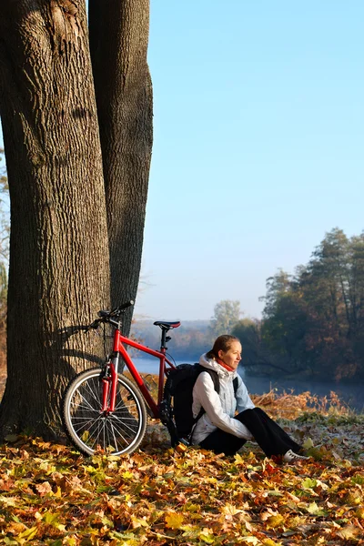 Happy woman cyclist enjoy the recreation autumn in nature