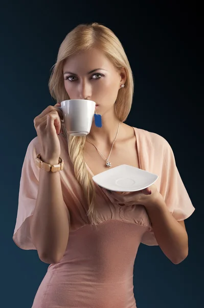 Blond sensual woman with tea set