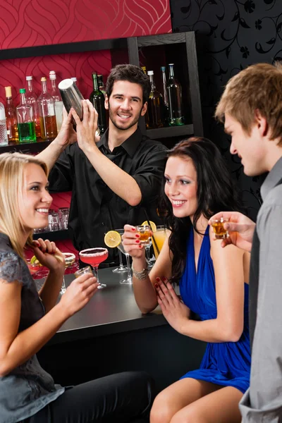 Barman cocktail shaker friends drinking at bar