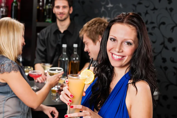 Party girl smiling with friends at bar
