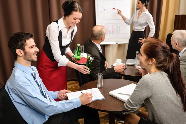 Waitress serving business conference room