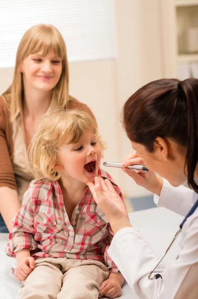 Pediatrician examine child throat look with light