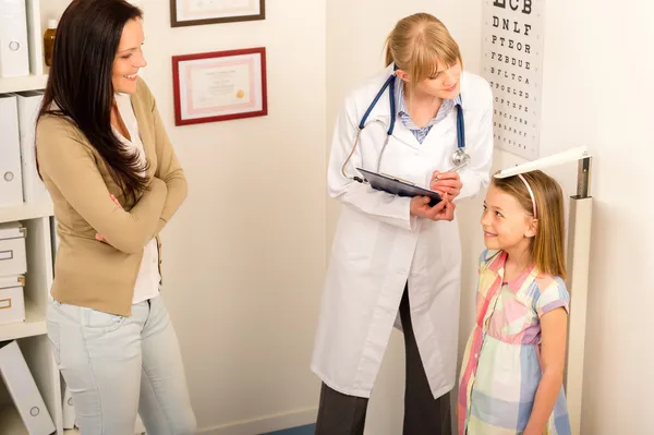 Medical check-up at pediatrist girl measure height