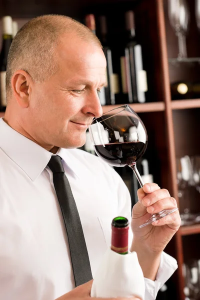 Bar waiter smell glass red wine restaurant
