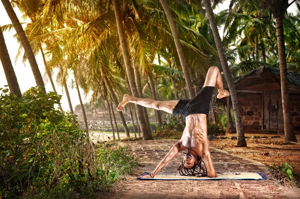 Yoga handstand pose in tropic