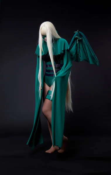 Blond girl in green fury cosplay character
