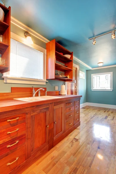 Custom build cherry kitchen with blue walls
