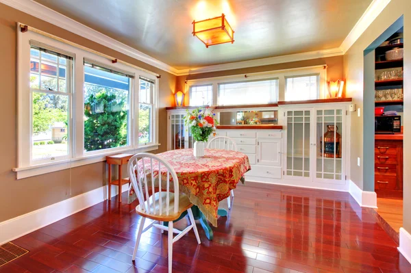 Dining room with chiny cherry floor and antique cabinets.