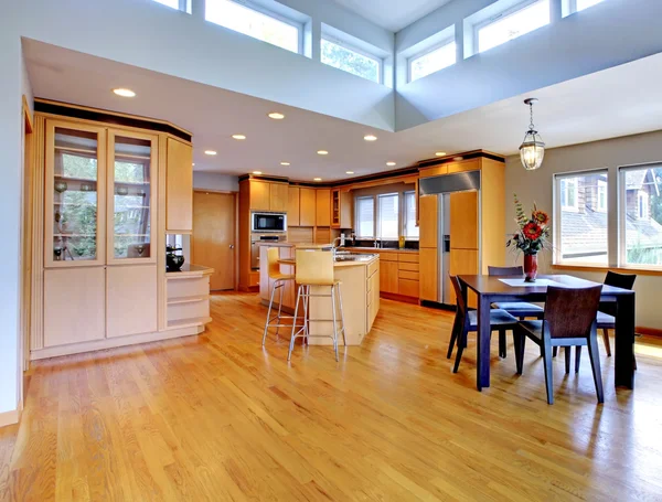 Large luxury modern wood kitchen with granite counter tops.