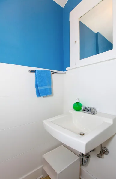 Small white and blue bathroom.
