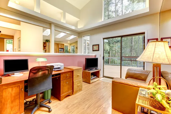 Home office interior with large windows.