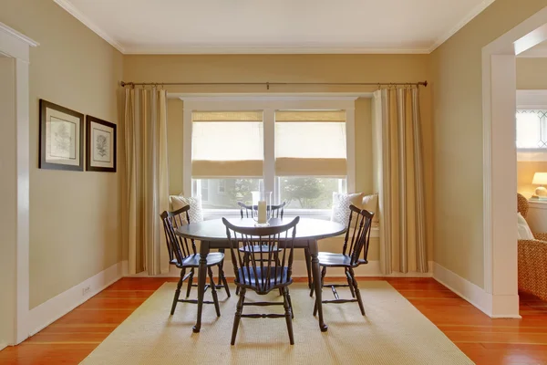 Elegant simple beige dinng room with curtains.