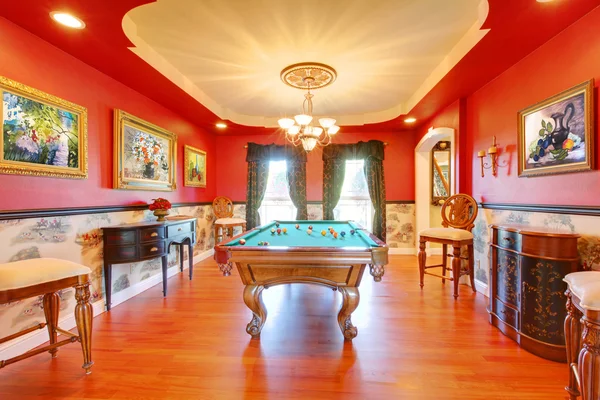 Red billiard luxury room with play pool.
