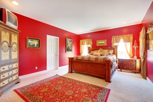 Red classic bedroom with large bed.