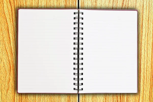 White notebook on the wood texture background.