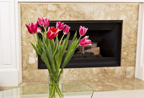 Flowers in front of fire place