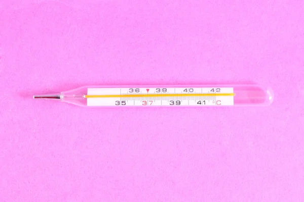 Thermometer isolated on the pink background
