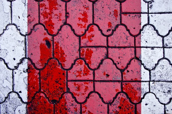 Background of red crosswalk on road paved by tiles