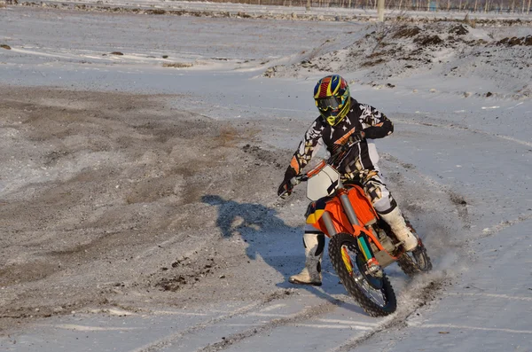 Motocross rider performs a right turn with the skid