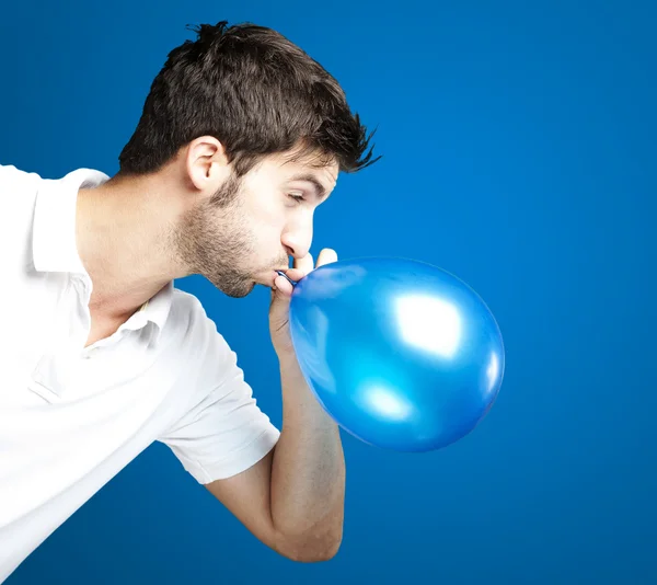 Man blowing balloon