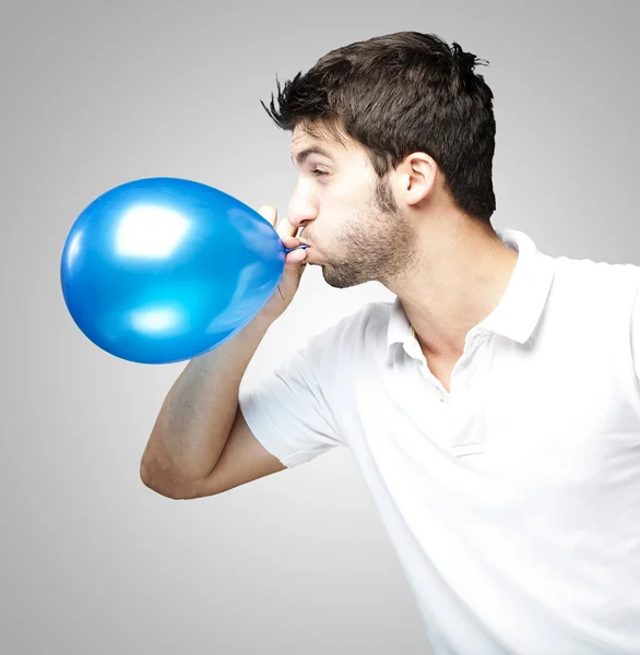 Man blowing balloon