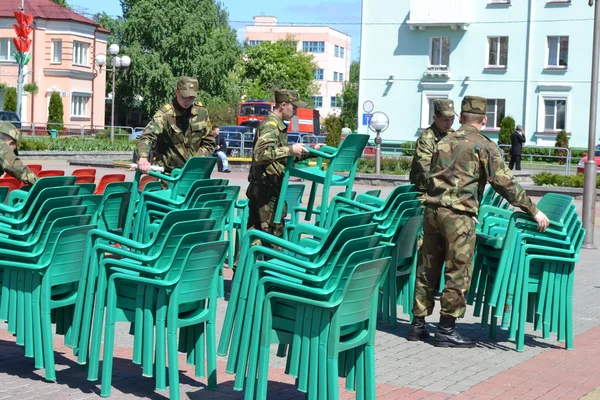 On a Victory Day holiday.Soldiers carry away chairs.