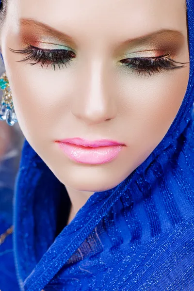 Woman with long eyelashes in blue