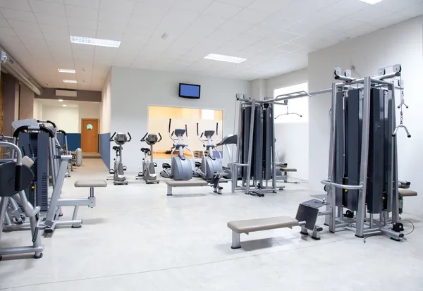Fitness club gym with sport equipment interior