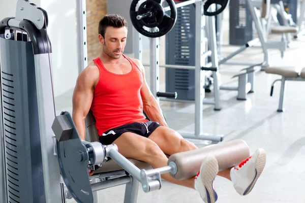 Man lifting weights with a leg press on sport gym