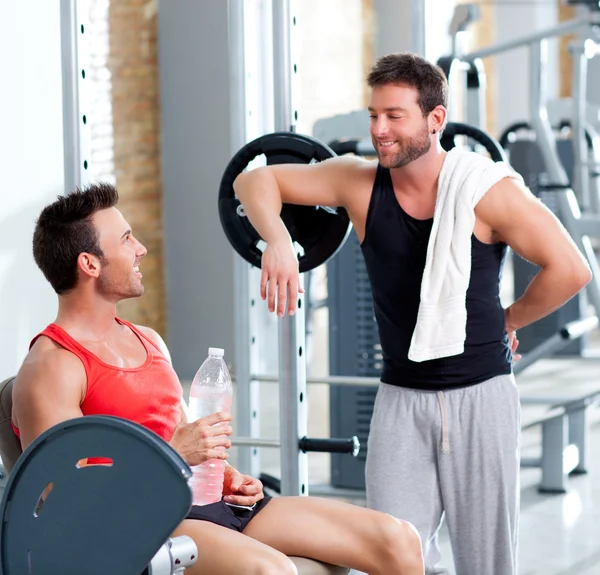 Two men on a sport gym relaxed after fitness