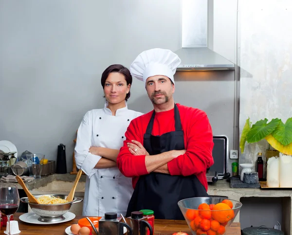 Chef couple man and woman posing in kitchen