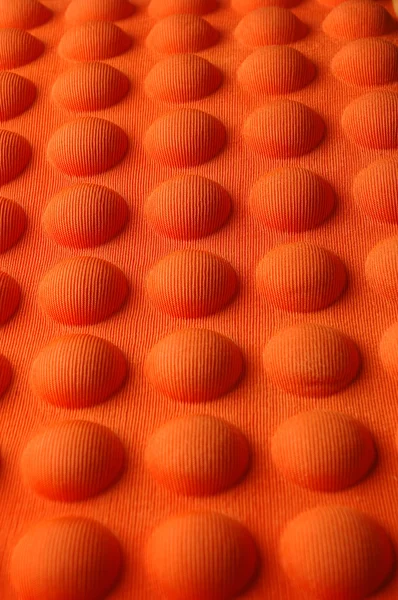 Detailed pattern of orange and brown seat cushion
