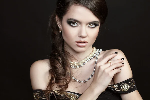 Beautiful woman with evening make-up. Fashion jewelry decoration