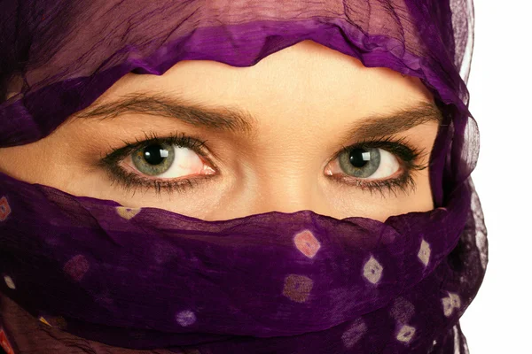 Closeup of a beautiful Indian or asian woman wearing a veil
