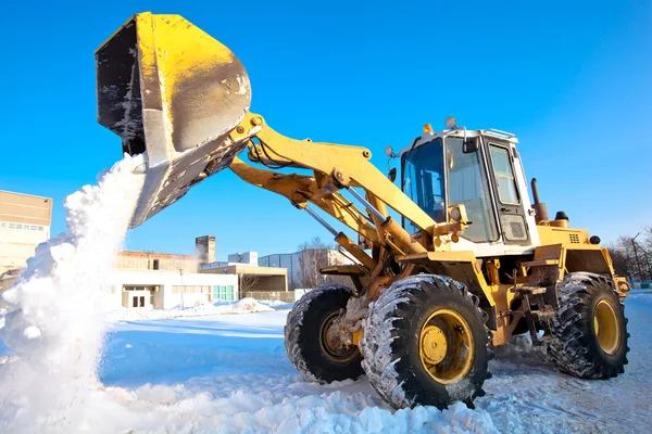 Wheel loader machine unloading snow