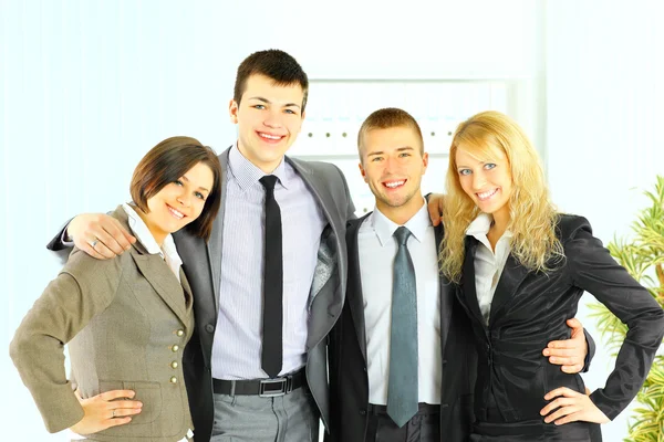 Happy smiling business team of young businessman and businesswoman in office