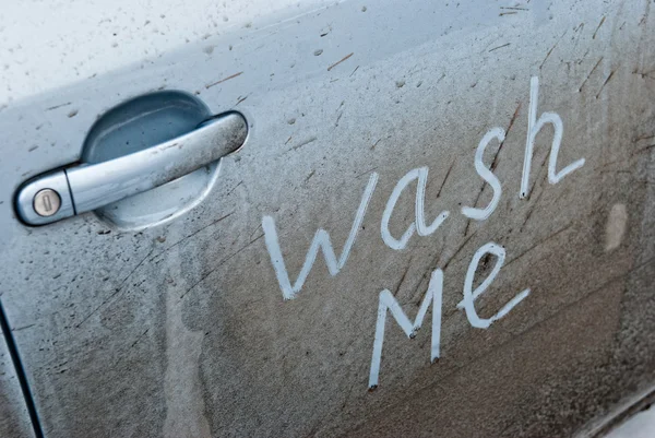 Inscription wash me in the car door