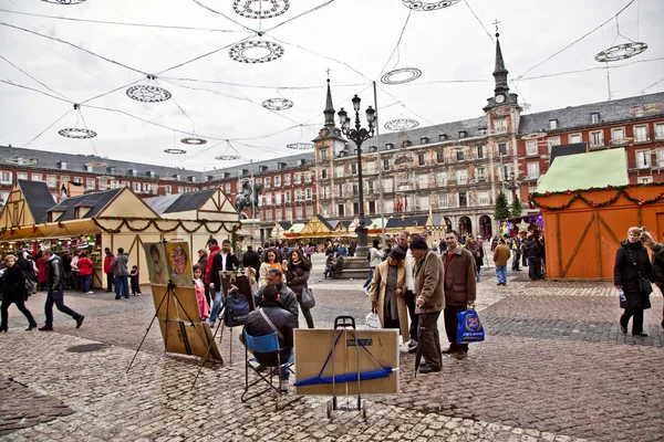 Painters offer their art at Madrids Plaza de major in Christmas