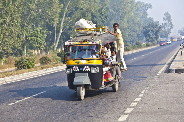 In overloaded cars on the Highway between Delhi and Agra