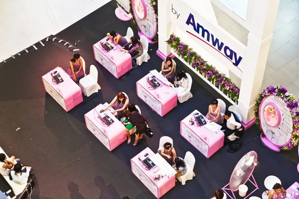 hostesses from amway are advising customers how to use their pro