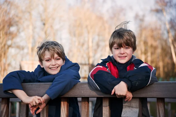 Outdoors portrait of two young happy brothers