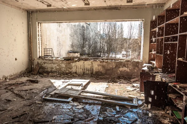 Water pouring down on wall in abandoned room in pripyat